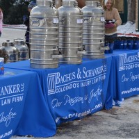 Event sponsor Bachus & Schanker serve hot drinks on a very chilly day at Dolls for Daughters