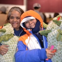 Happy holidays for families receiving gifts at Dolls for Daughters