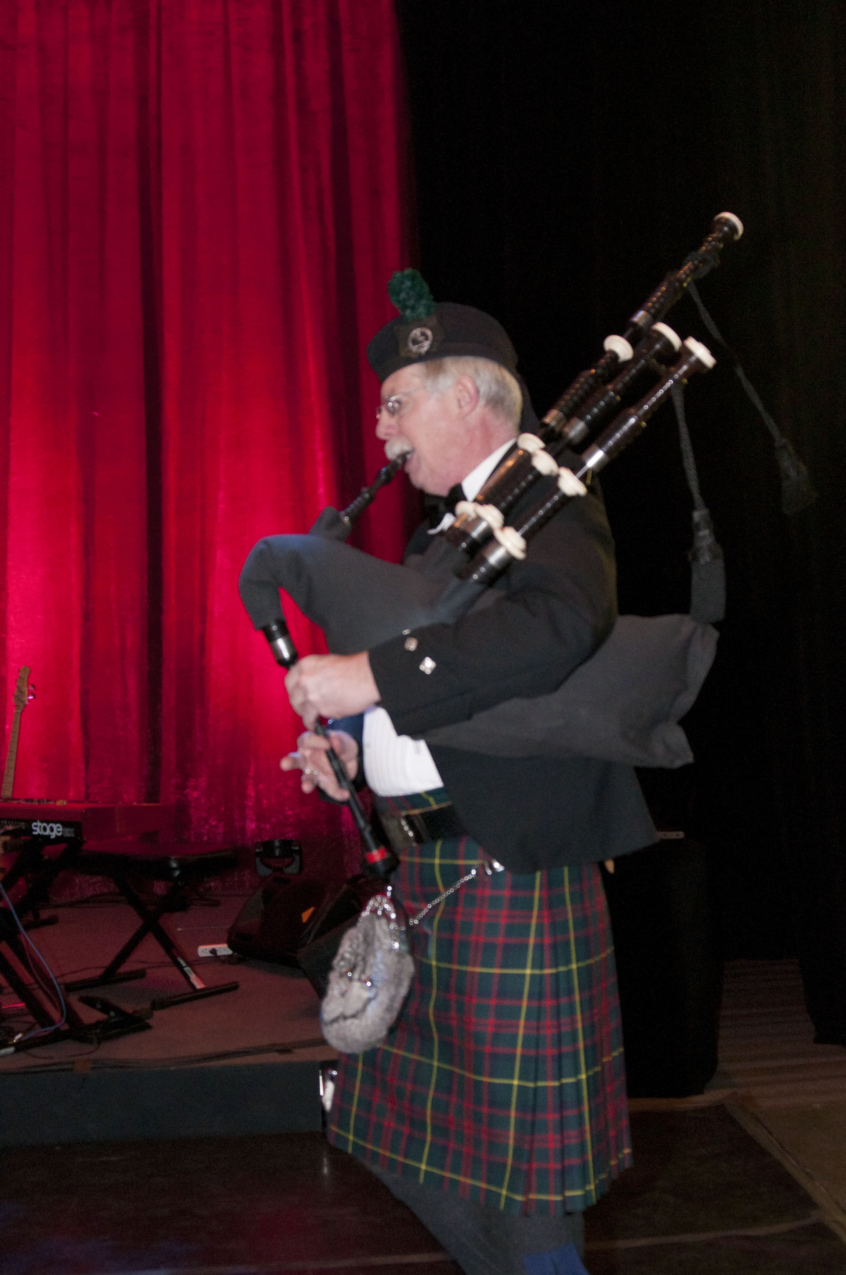 A bagpipe player performs at Green Tie Gala