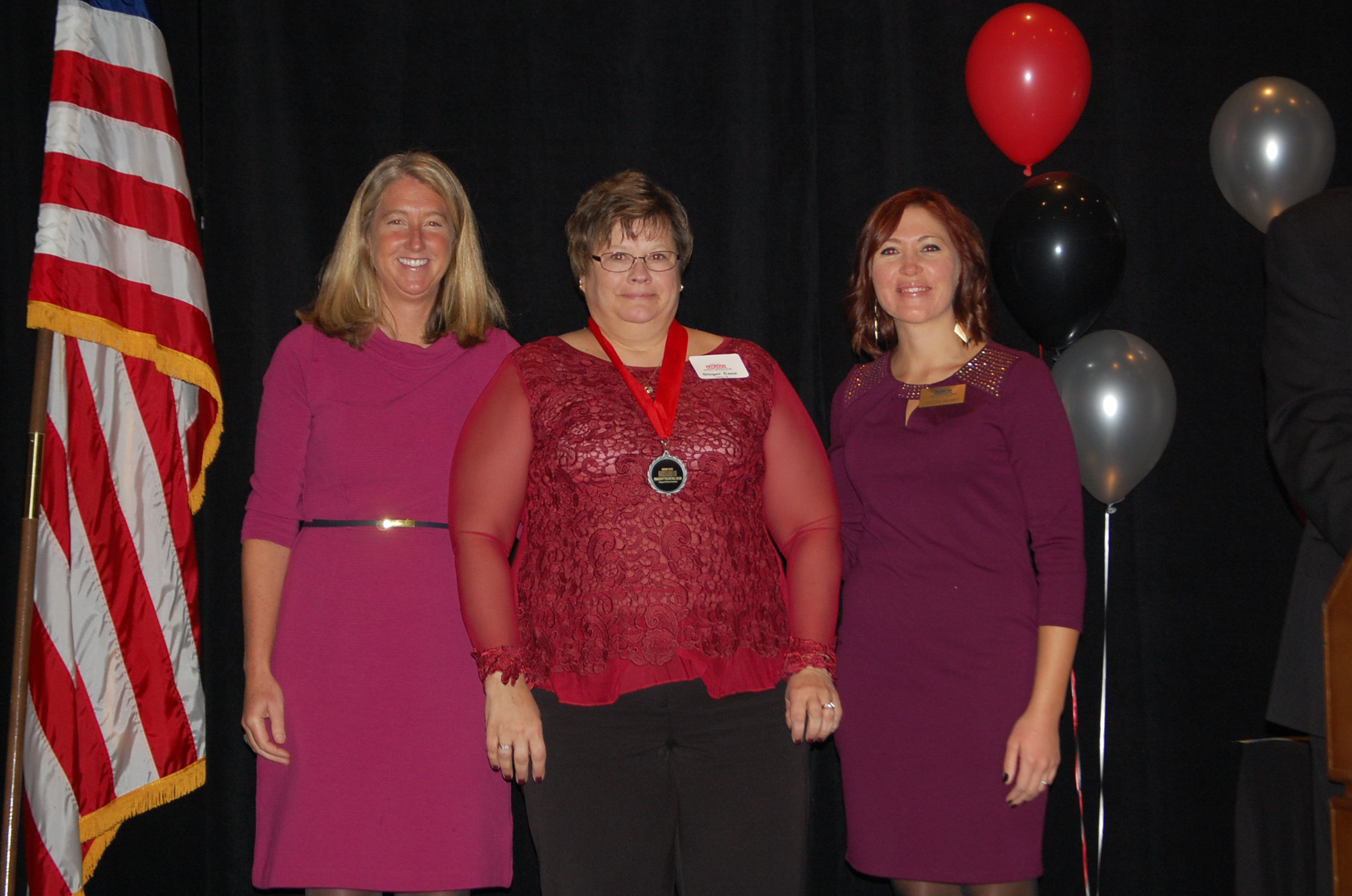 Cary Kennedy and Jaclyn Wilmot with Ginger Case, July's honoree, center