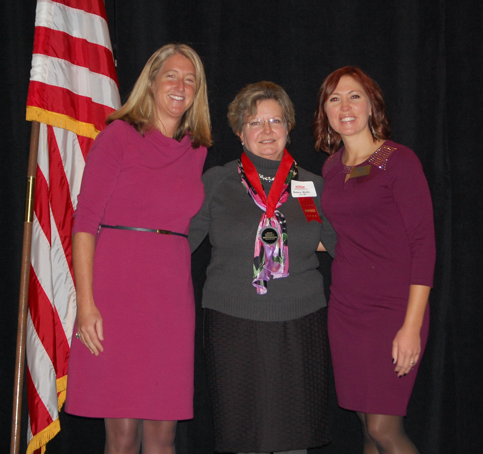 Cary Kennedy and Jaclyn Wilmot with August honoree Deb Wells, center