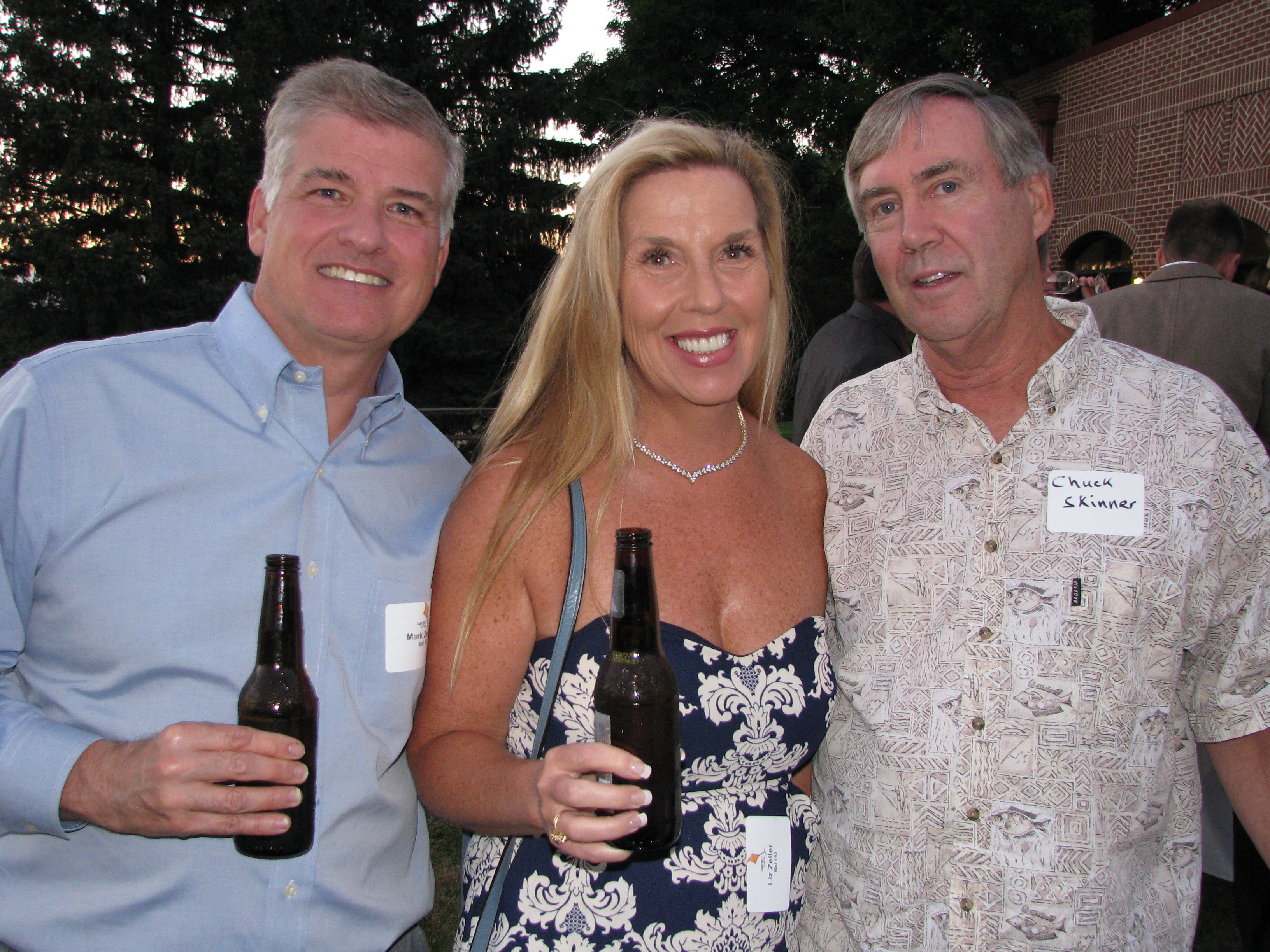 Mark and Liz Zeller, left, catch up with Chuck Skinner