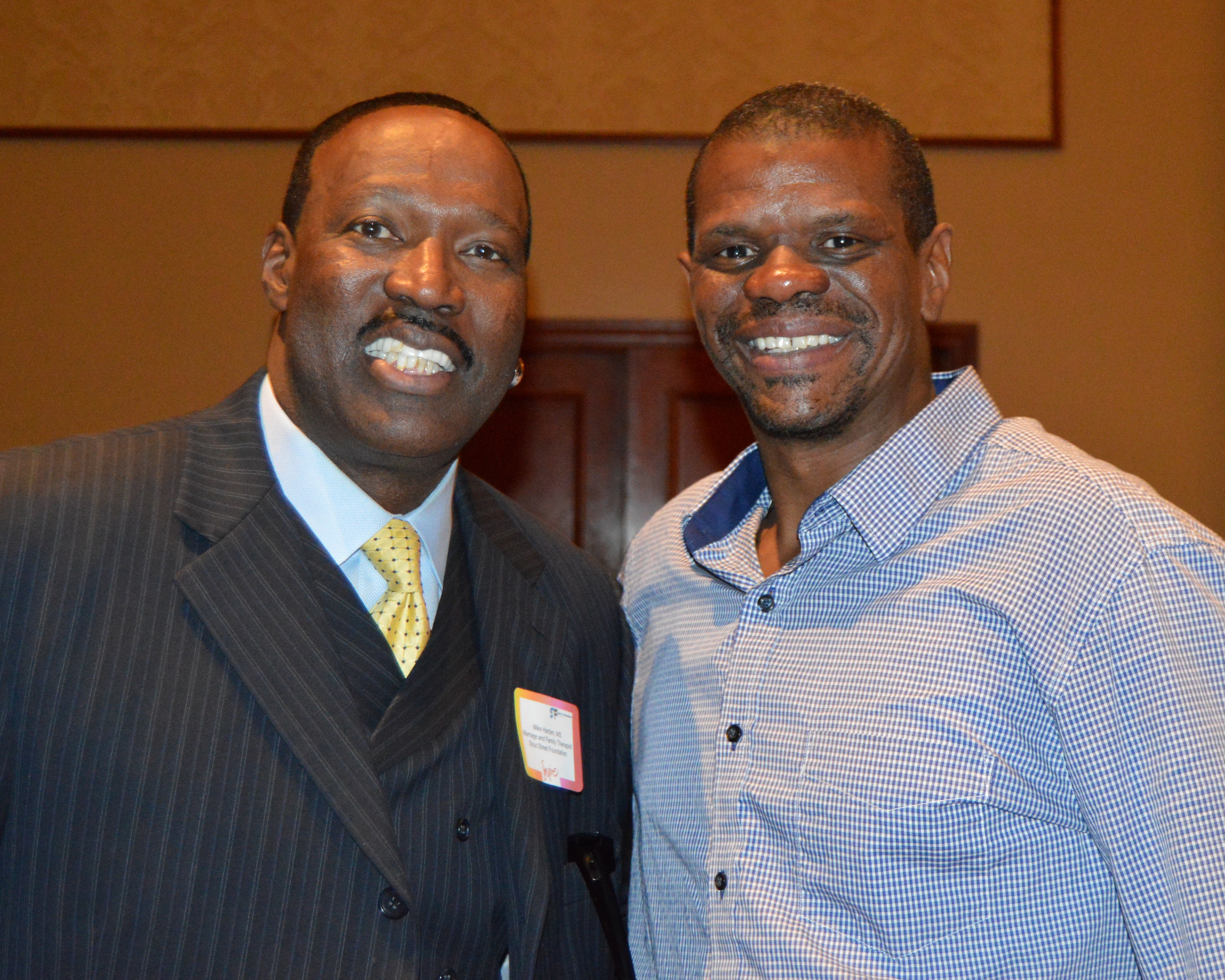 Friends and former Denver Bronco greats Mike Harden (left) and Tyrone  Braxton