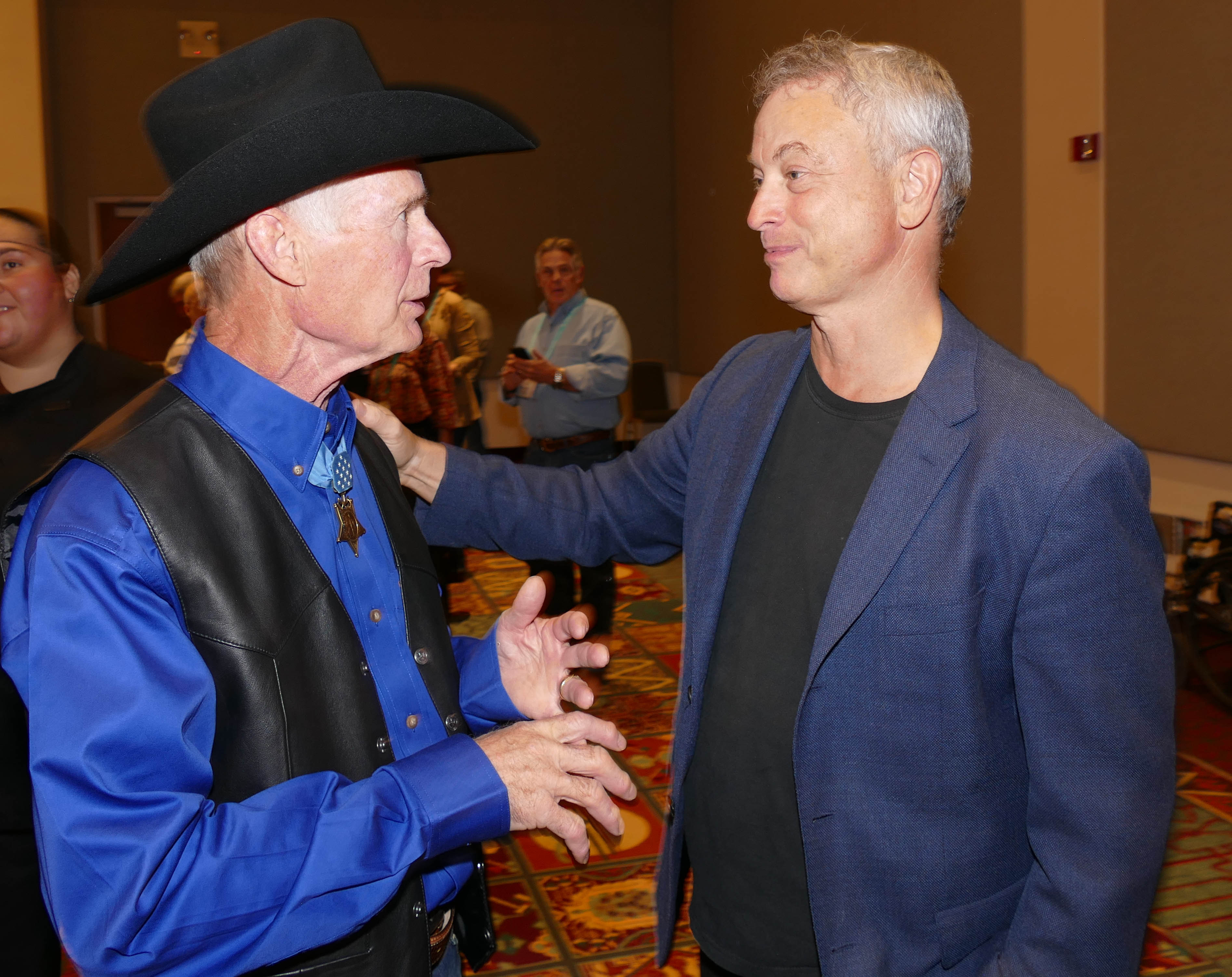 Recipient and retired Navy SEAL Tommy Norris, left, chats with Gary Sinise