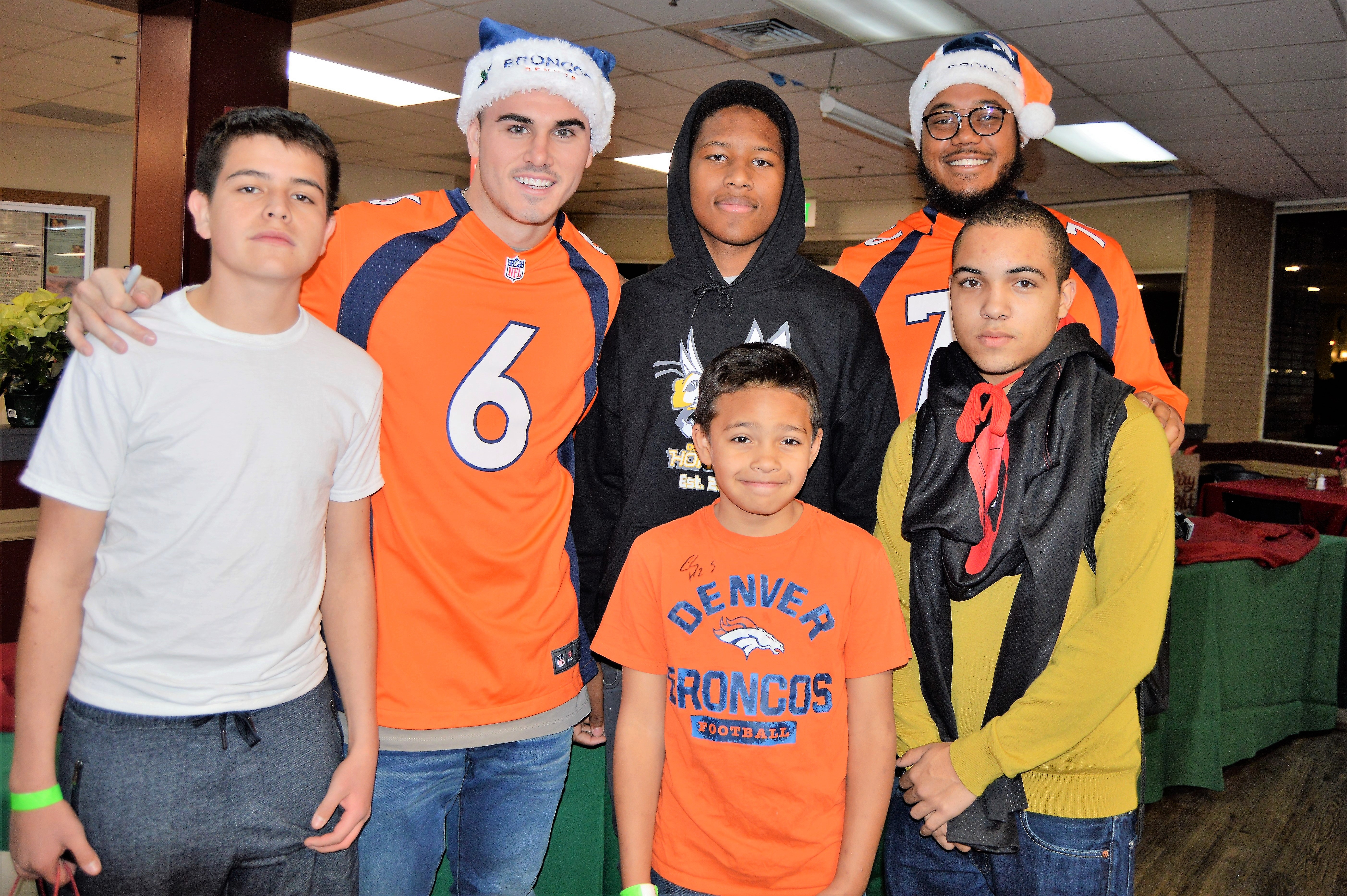 Posing with Broncos Chad Kelly (6) and Max Garcia