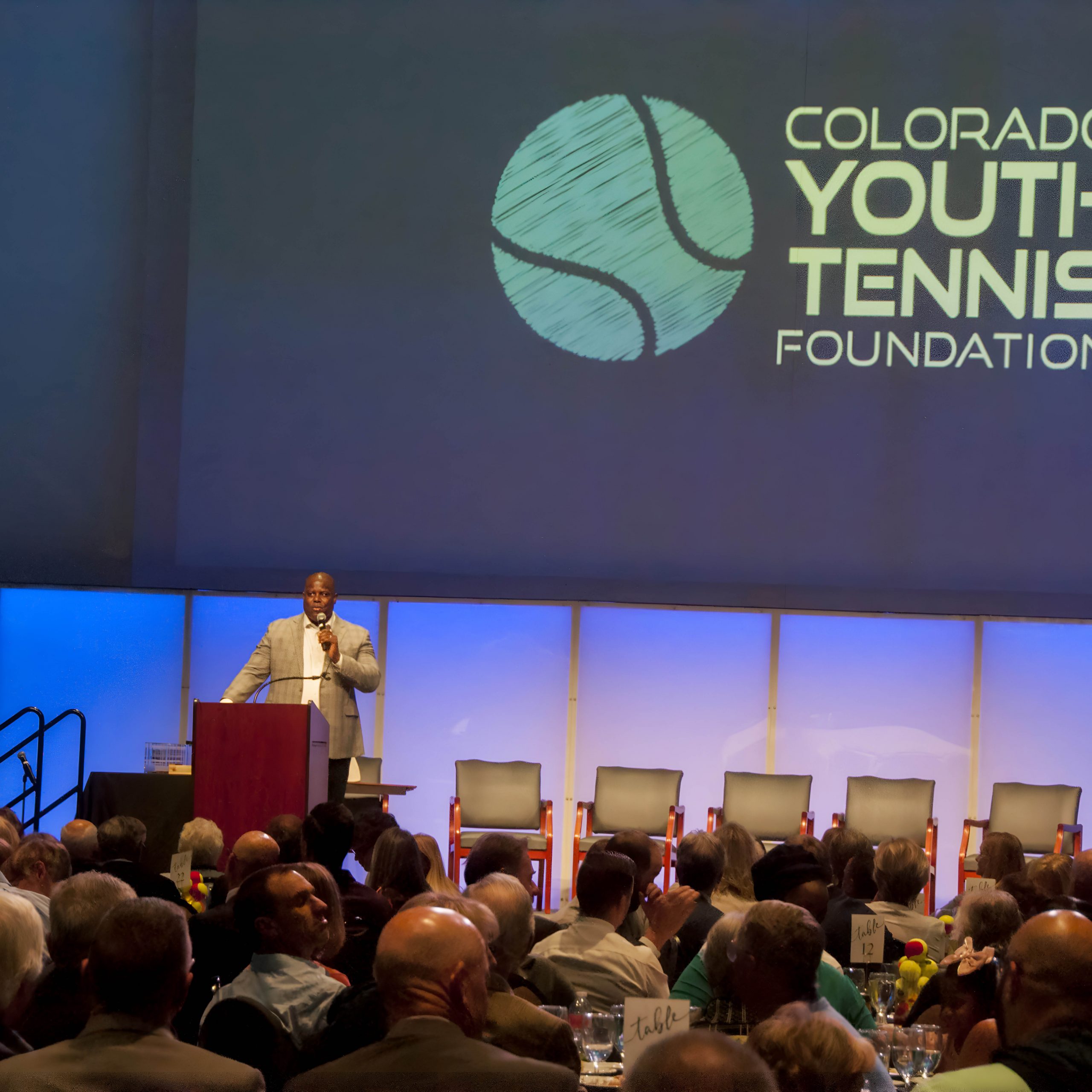 Auctioneer Reggie Rivers describes the live auction items available